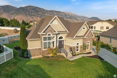 View of front facade with stone siding, stucco siding, and a shingled roof