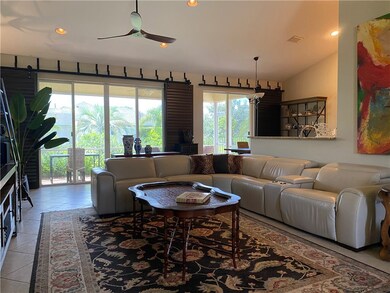 living area showing 2 sliders out to large covered
