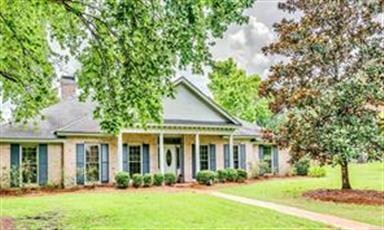 Corner lot, mature landscaping, showcasing a beaut