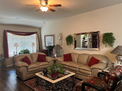 Living area with vinyl wood finished floors and ceiling fan