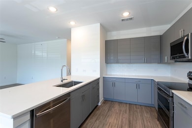 Kitchen featuring appliances with stainless steel