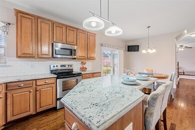 The breakfast room slider exits to the fenced, level back yard!