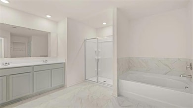 Bathroom with a stall shower, marble finish floors