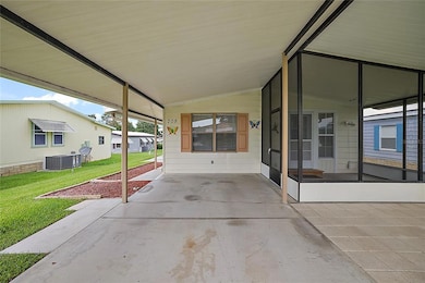 Carport area, screened porch, covered patio and side walk one left heading to workshop/storage area.