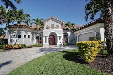 Mediterranean / spanish home featuring a front lawn and a garage