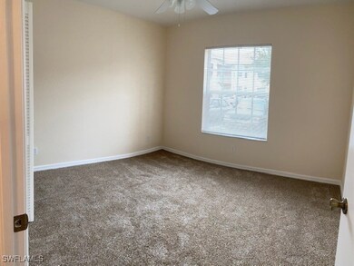 Carpeted empty room featuring baseboards and a cei
