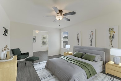 Bedroom with wood finished floors and a ceiling f