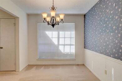 Unfurnished dining area with an inviting chandelie