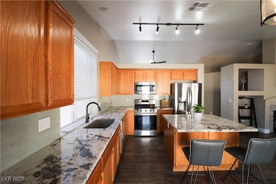 Kitchen with stainless steel appliances, a sink, l