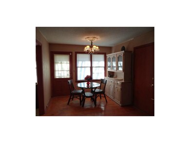 The Formal Dining Room With Hardwood Floors & Pati