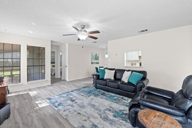 Living room with wood finished floors, ceiling fa