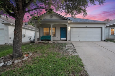 View of front of home featuring a porch, a garage