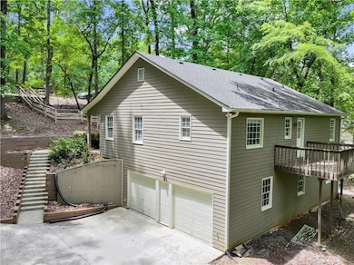 View of property exterior with an attached garage,