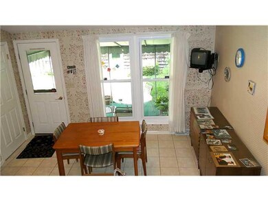 Kitchen. View of eating area and awning-covered pa