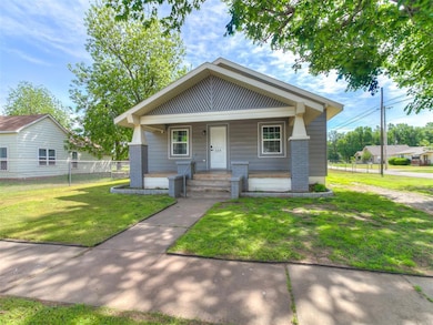 View of front of home with a porch and brick sidin