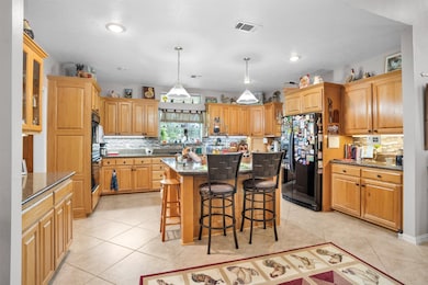 Well-appointed kitchen featuring abundant storage, rich oak cabinetry, and elegant granite countertops.