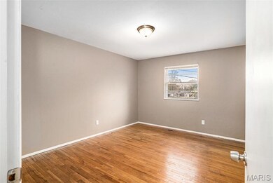 Spare room featuring hardwood / wood-style floors and baseboards