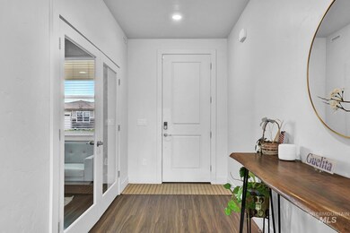 Foyer entrance with dark wood-type flooring and baseboards