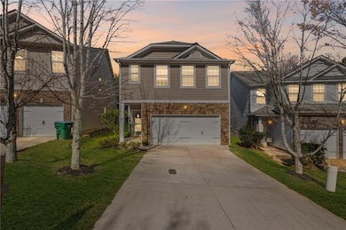 View of front of property with driveway, a garage,