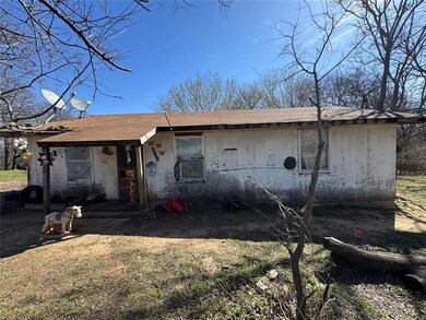 Rear view of property featuring a shingled roof