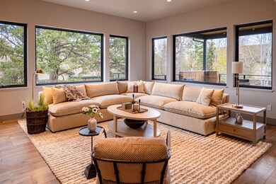 Living area with recessed lighting, a wealth of natural light, and hardwood / wood-style floors