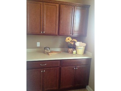 Sunny laundry room has tons of laundry cabinets fo