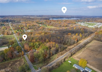 Aerial view of property and Chippewa lake located near by