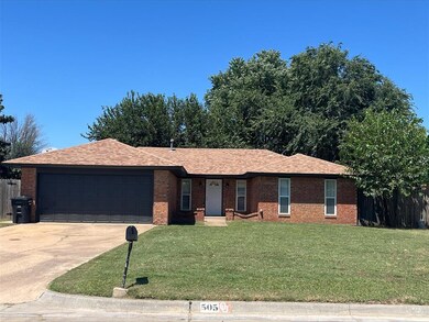 Ranch-style house with a garage and a front lawn