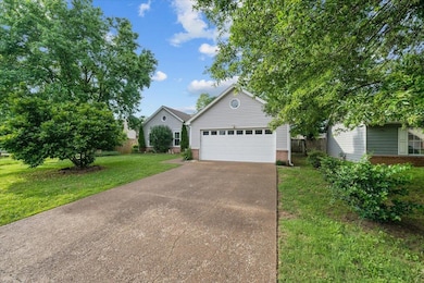 View of front of home featuring brick siding and driveway