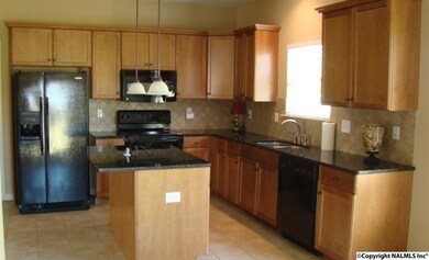 Spacious kitchen offers Granite Counter tops, Island, plentiful cabinets, window view from kitchen sink.