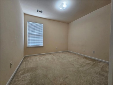 Unfurnished room with light carpet and baseboards