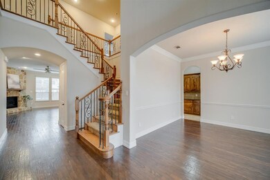 This view from the front entry showcases the beautiful staircase with a views into the family room and dining room.