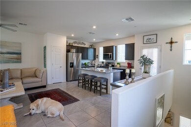 Living area featuring light tile patterned flooring, recessed lighting, and ceiling fan