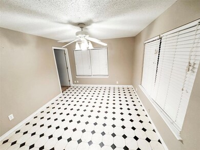 Unfurnished dining area featuring ceiling fan and a textured ceiling