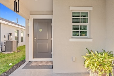 Entrance to property featuring stucco siding and c