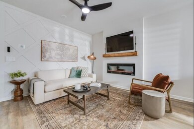 Living area featuring a ceiling fan, wood finished