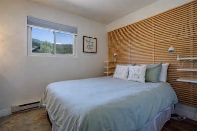 Bedroom with a baseboard radiator