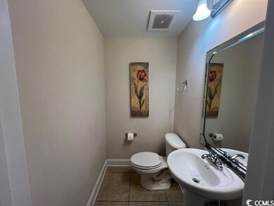 Bathroom featuring tile patterned flooring, toilet