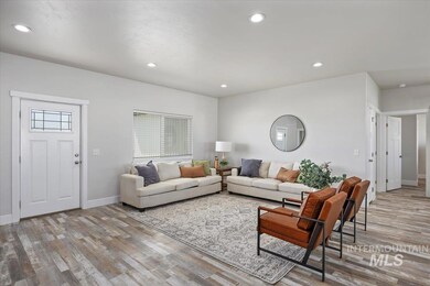 Living area with wood finished floors and recessed lighting