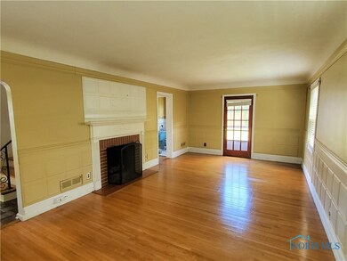 Living room with hard wood floors and a gas firepl