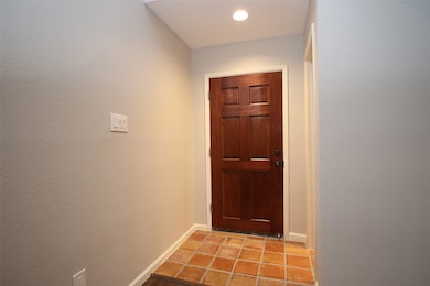 The Entry is graced by a richly stained wood door