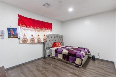Bedroom with hardwood / wood-style floors
