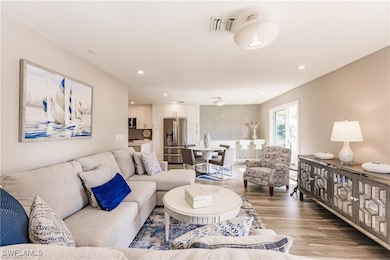 Living room offers good natural lighting, neutral color palette