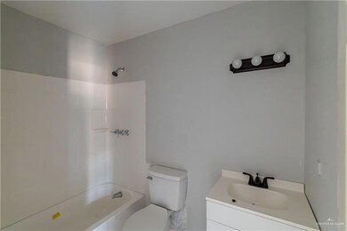 Full bathroom featuring washtub / shower combination, vanity, and toilet
