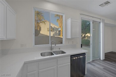 Kitchen with wood finished floors, visible vents,