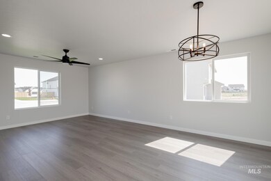Unfurnished room with dark wood finished floors, recessed lighting, a chandelier, and ceiling fan