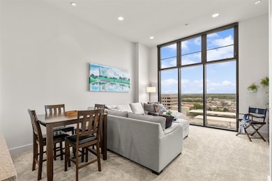 Carpeted living area with expansive windows, reces