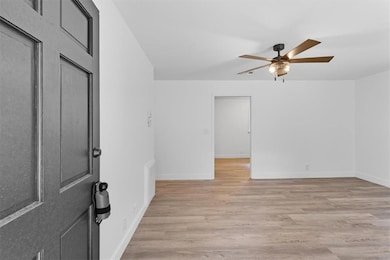 Unfurnished room featuring light wood-style floors and ceiling fan
