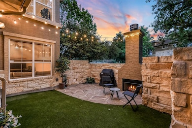Patio terrace at dusk featuring an outdoor stone 