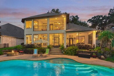 Beautifully lit at night, this home offers two scr